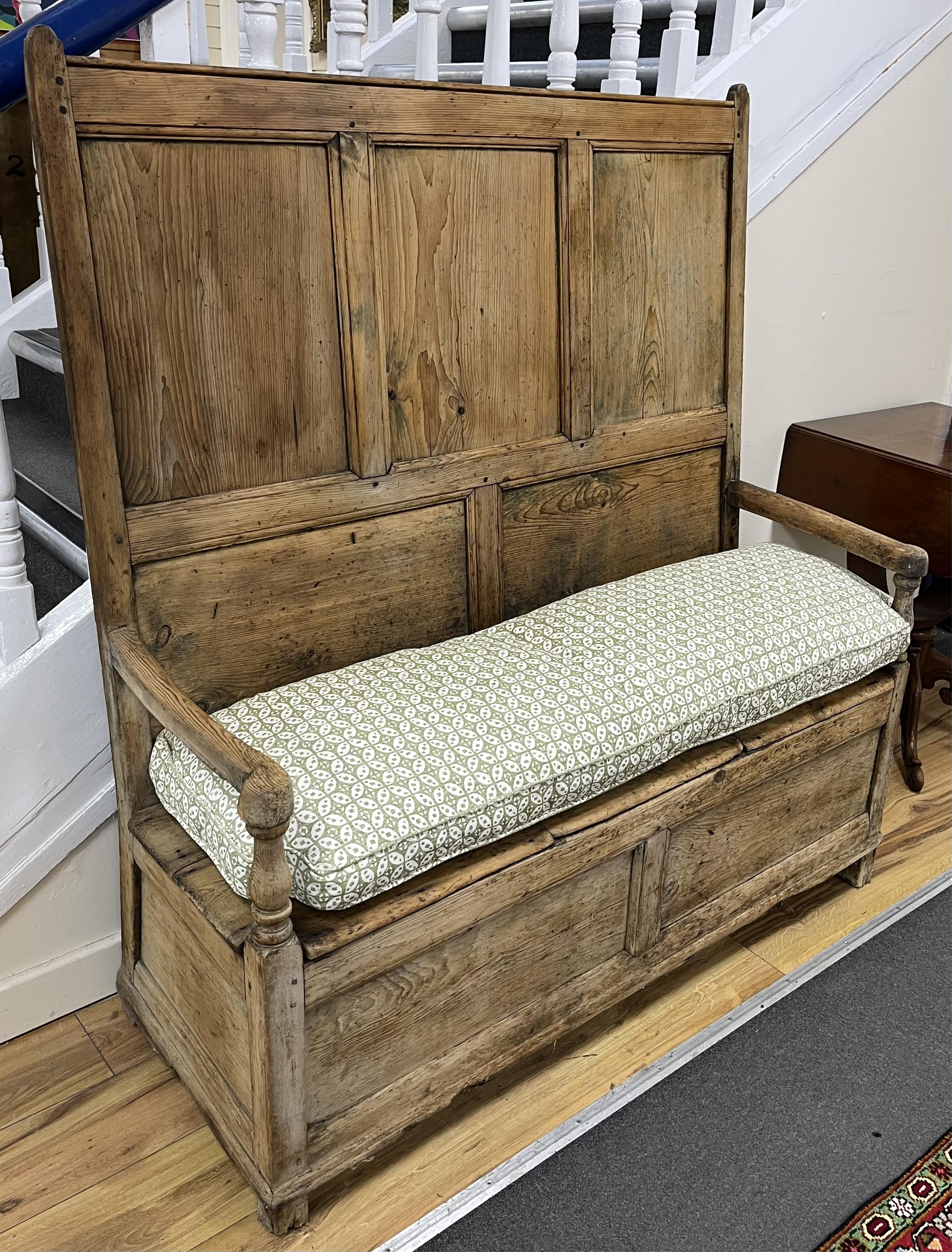 An 18th century panelled pine settle, width 127cm, depth 46cm, height 140cm. Condition - poor to fair